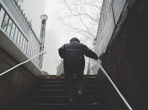 Walking while holding railing in the snow