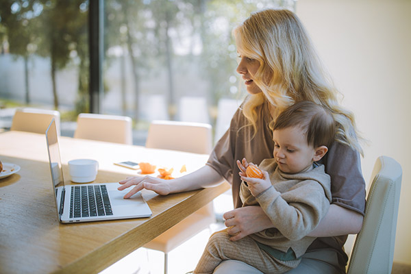 Woman and toddler having a virtual visit with their family doctor pediatrician from home