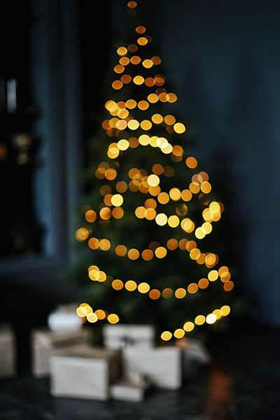 Christmas tree out of focus in a dark room