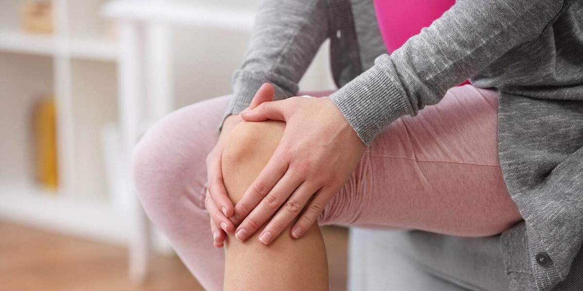 Woman Experiencing Joint Pain & Knee Pain When Exercising and walking