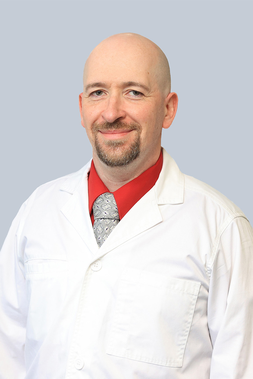 Photo of Daniel Branzburg in a white coat, certified registered nurse practitioner who now provides family medicine healthcare at Troy Laurel Health Center, located at 45 Mud Creek in Troy, PA