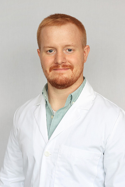 Photo of Spencer Castle in a white coat, certified registered nurse practitioner who now provides family medicine healthcare at Mansfield Laurel Health Center, located at 416 South Main Street in Mansfield, PA