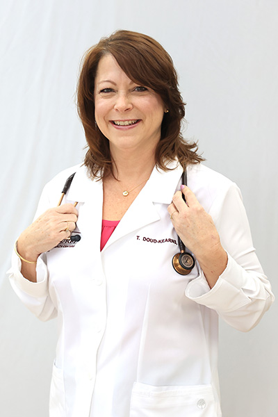 Photo of Tina Doud-Kearns in a white coat, certified registered nurse practitioner who now provides family medicine healthcare at Blossburg Laurel Health Center, located at 6 Riverside Plaza in Blossburg, PA