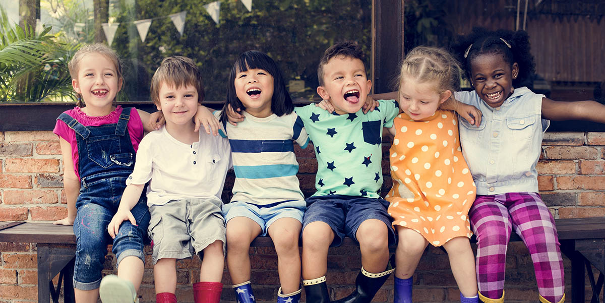 Diverse group of children laughing together; make back to school wellness easy with Laurel Health’s walk-in school physical days