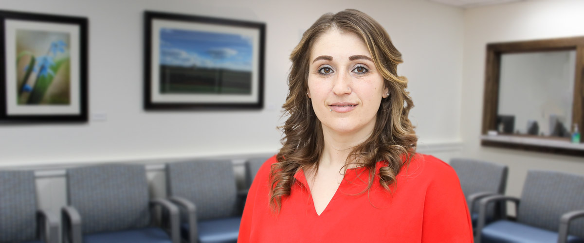 Jessica Lonzi-McVay, licensed clinical social worker, standing in the Laurel Behavioral Health office lobby. She provides mental and behavioral health services.