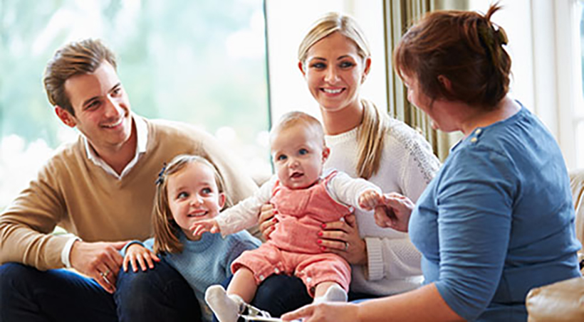 Parents meeting a medical professional about family wellness.