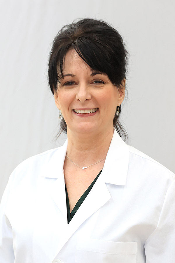 Marcelinda Griffiths, certified registered nurse practitioner (CRNP), standing in her white coat. Marcelinda is spearheading Women's Health Day at Mansfield Laurel Health Center on August 19, 2026. Call 570-662-2002 to make an appointment.